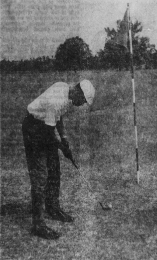 a golfer lines up a putt